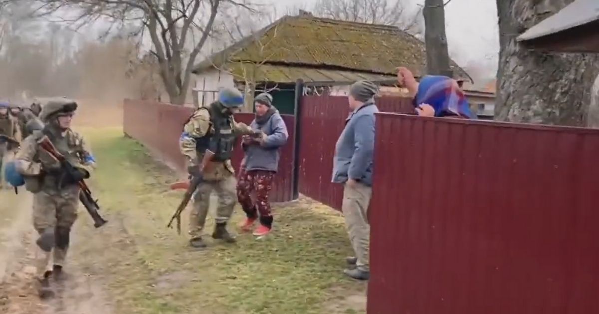 Residents of the village of Nova Basan greet Ukrainian troops.