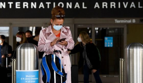 A woman wears a face mask outside the Tom Bradley International Terminal at Los Angeles International Airport in January 2021.
