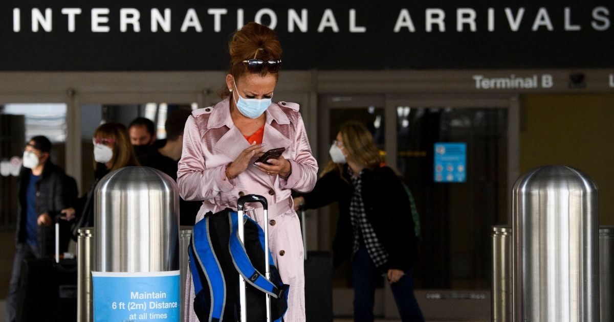 A woman wears a face mask outside the Tom Bradley International Terminal at Los Angeles International Airport in January 2021.