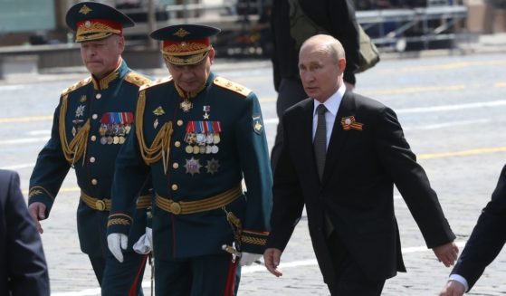 Russian President Vladimir Putin is pictured in a 2020 file photo marching with Russian Defense Minister Sergei Shoigu as part of a Moscow parade marking 75th anniversary of surrender of Nazi Germany during World War II.