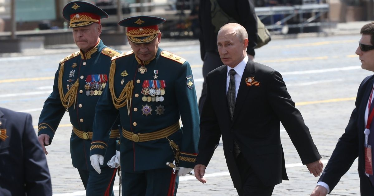 Russian President Vladimir Putin is pictured in a 2020 file photo marching with Russian Defense Minister Sergei Shoigu as part of a Moscow parade marking 75th anniversary of surrender of Nazi Germany during World War II.