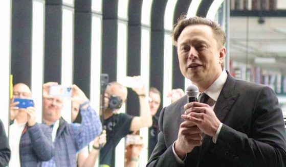 SpaceX and Tesla CEO Elon Musk, right, is pictured in a March file photo at the opening of a Tesla plant near Gruenheide, Germany.