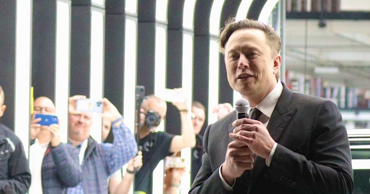 SpaceX and Tesla CEO Elon Musk, right, is pictured in a March file photo at the opening of a Tesla plant near Gruenheide, Germany.