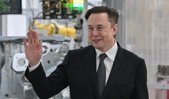 Mega-billionaire and Tesla CEO Elon Musk waves in a file photo from a visit to an electic car plant in Gruenheide, Germany, in March.
