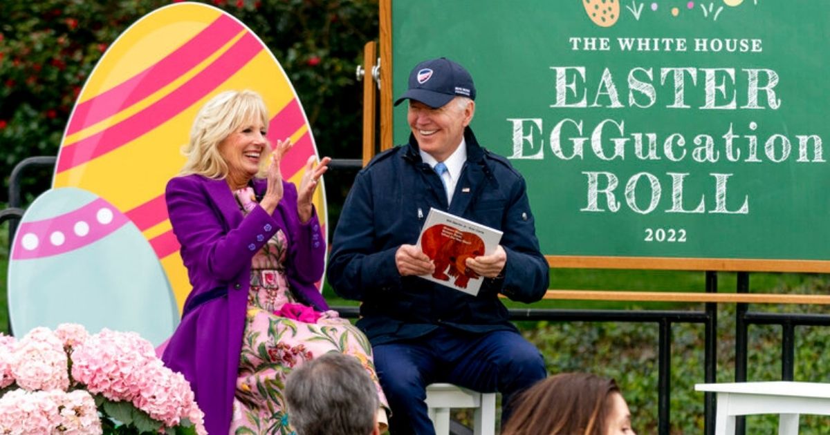 President Joe Biden helps first lady Jill Biden read a storybook during the White House Easter Egg Roll Monday in Washington.