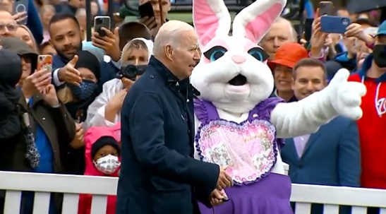 President Joe Biden is shooed away from reporters by an Easter Bunny at Monday's White House Egg Roll.