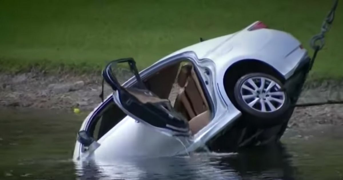 a car being pulled from a lake