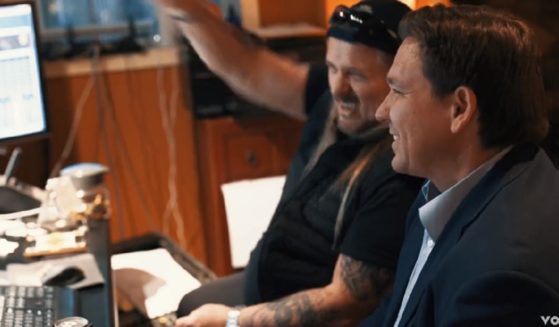 Lynyrd Skynyrd vocalist Johnny Van Zant listens with Florida Gov. Ron DeSantis to "Sweet Florida," a song by Van Zant and his brother, Donnie Van Zant, in a video that was released on Friday.