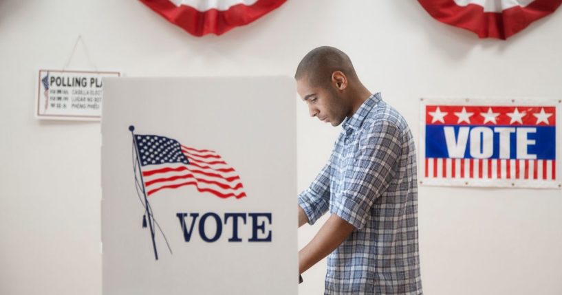 A man votes in this stock image.