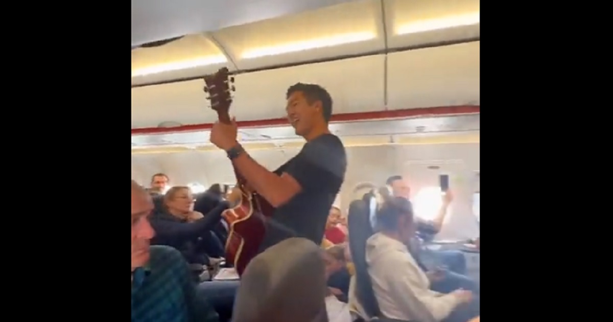 Pastor Jack Jensz Jr. leads a song aboard a plane in a video originally posted to Facebook April 9.