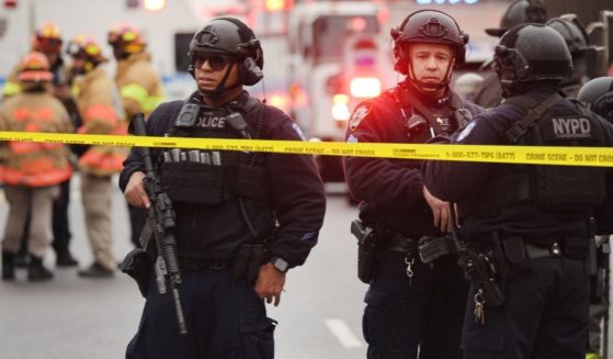 Police and emergency responders gather at the site of a shooting on Tuesday in the Brooklyn borough of New York City.
