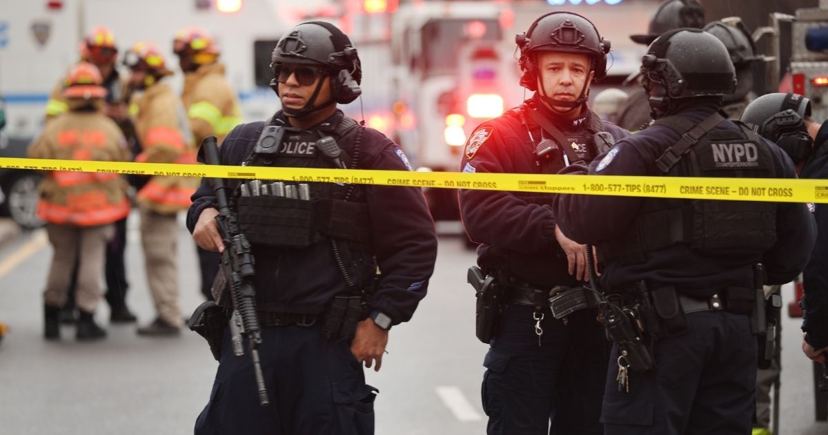Police and emergency responders gather at the site of a shooting on Tuesday in the Brooklyn borough of New York City.