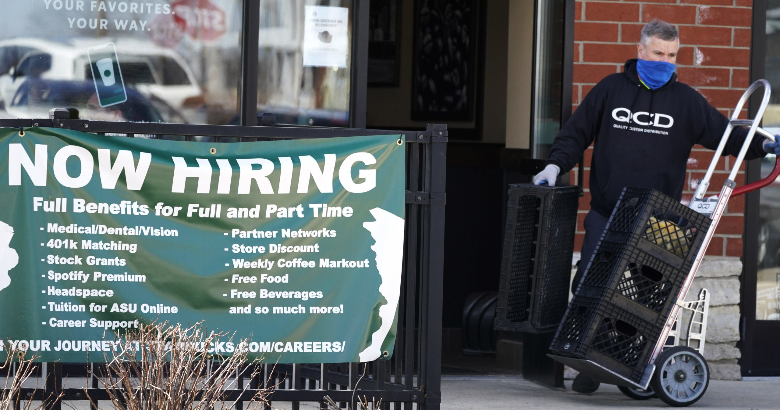 A hiring sign is displayed outside of a Starbucks in Schaumburg, Illinois, on April 1.