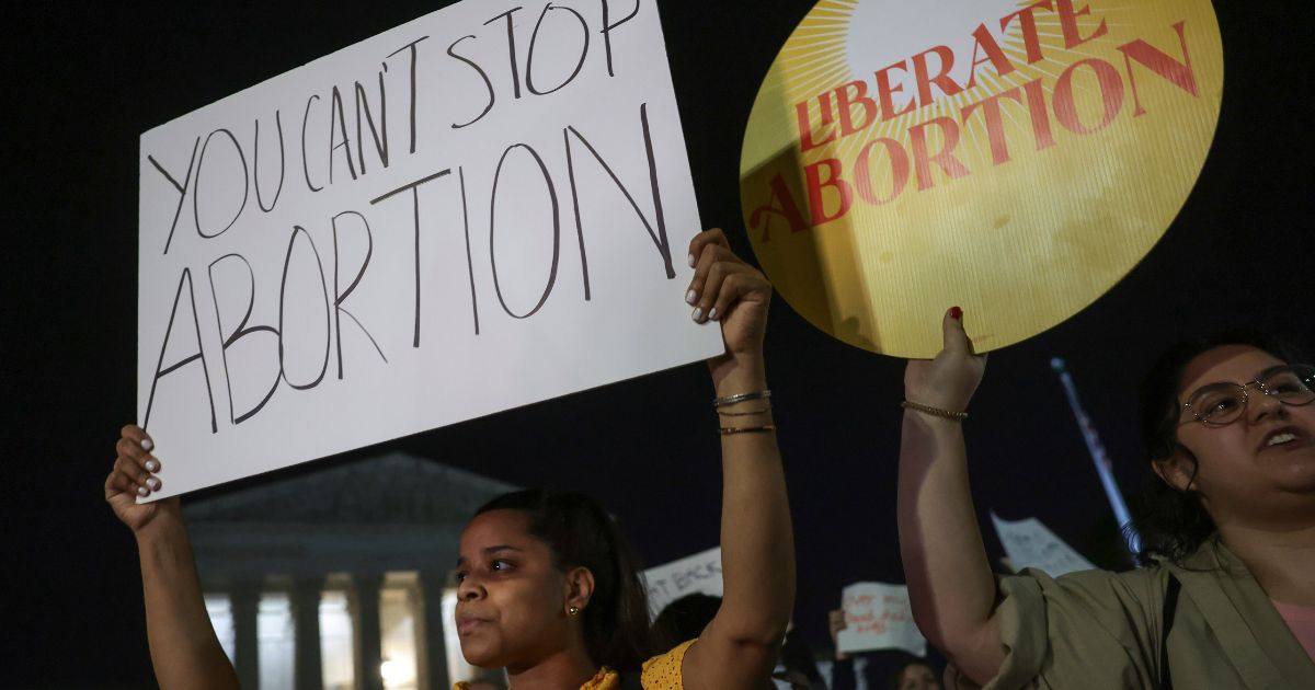 Pro-abortion activists rally outside of the U.S. Supreme Court in Washington on Monday night.