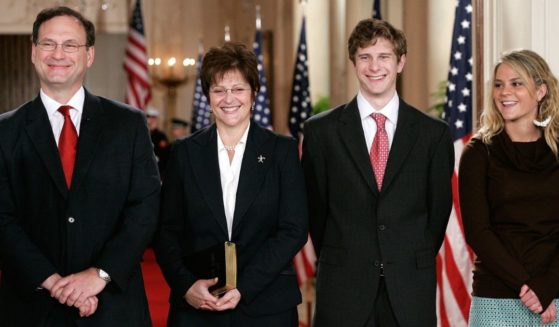 Supreme Court Justice Samuel Alito, left, and his wife Martha-Ann Bomgardner, second from left, son Philip, second from right, and daughter Laura, right, attend a ceremonial swearing-in for the newly confirmed justice at the East Room of the White House February 1, 2006.