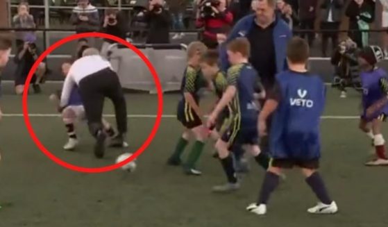 Australian Prime Minister Scott Morrison lost his balance and fell on a young soccer player Wednesday while taking part in a training match for players under age 8.