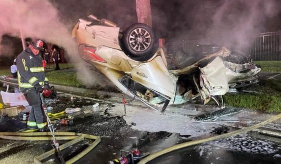 A firefighter works the scene of a fiery crash in Orlando, Florida.