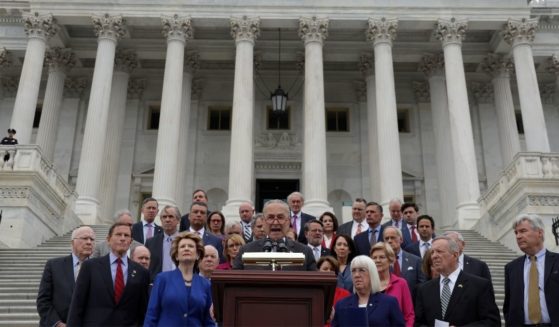 Senate Majority Leader Chuck Schumer speaks as Democratic senators listen on the steps of the U.S. Capitol on Tuesday in Washington, D.C.
