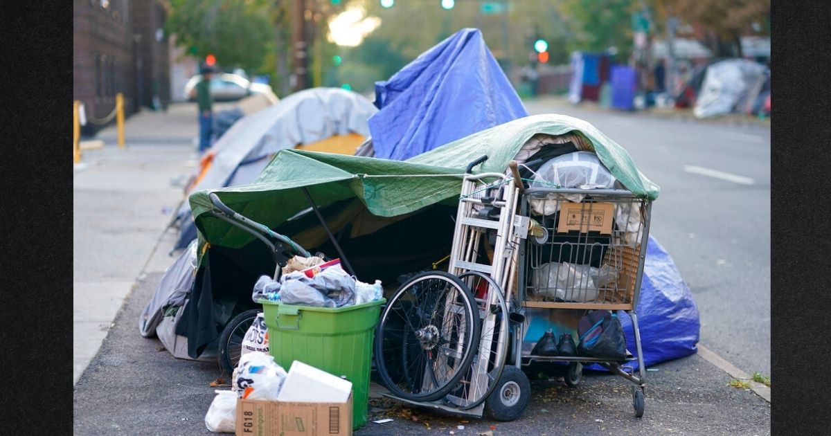 Belongings sit outside a row of tents during a sweep of a homeless encampment in downtown Denver in a file photo from October 2020.