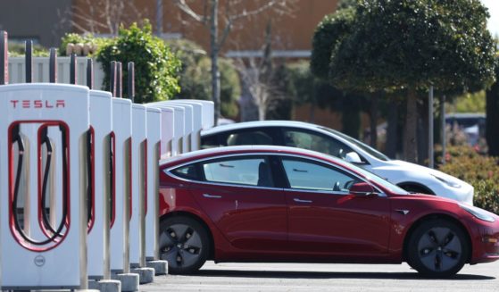 Two Tesla electric vehicles recharge at a supercharging station in Petaluma, California, on Monday.