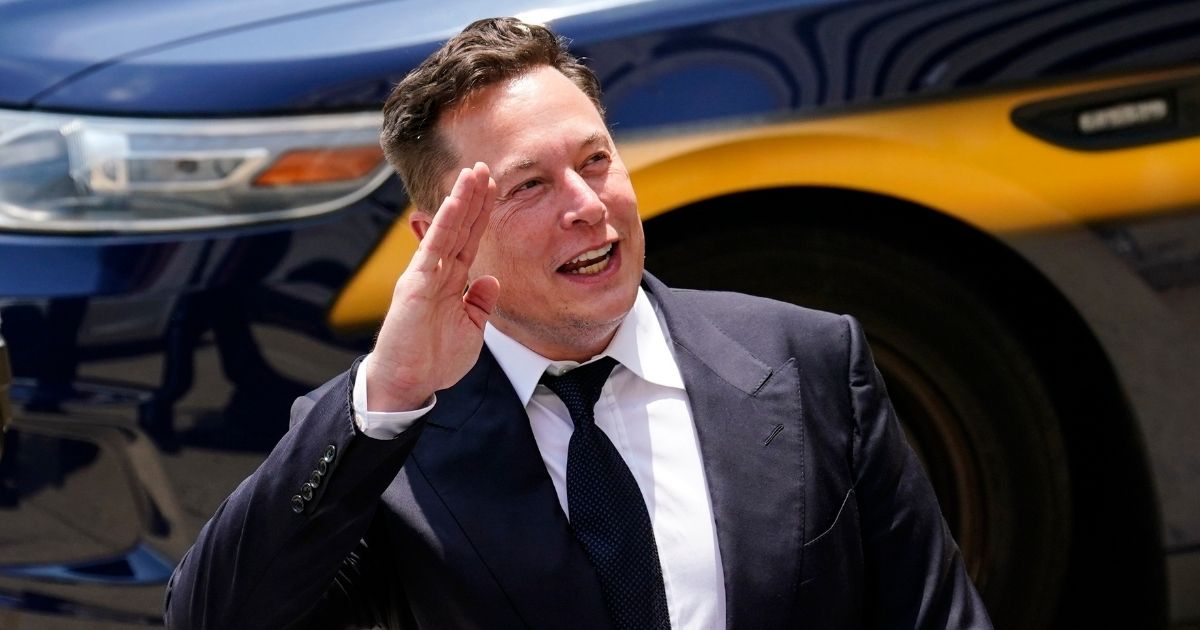 Tesla CEO Elon Musk waves as he departs the justice center in Wilmington, Delaware, on July 13, 2021.