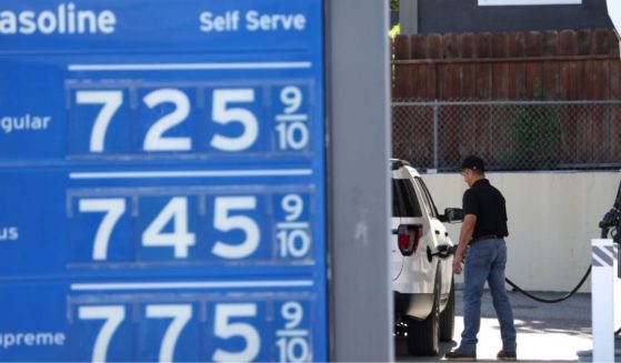 A man fills his gas tank on Wednesday in Menlo Park, California, where gas prices are over $7 a gallon.