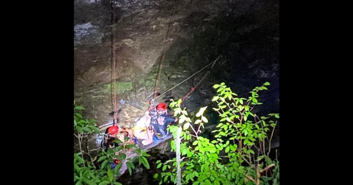 Rescuers assist a 17-year-old girl who had fallen from a waterfall in Georgia.