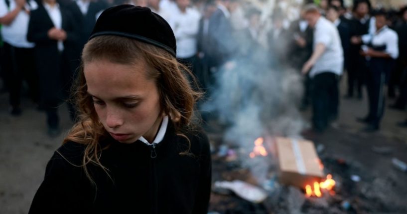 A boy looks on as ultra-Orthodox Jews take part in an annual pilgrimage in the northern Israeli village of Meron on Thursday.