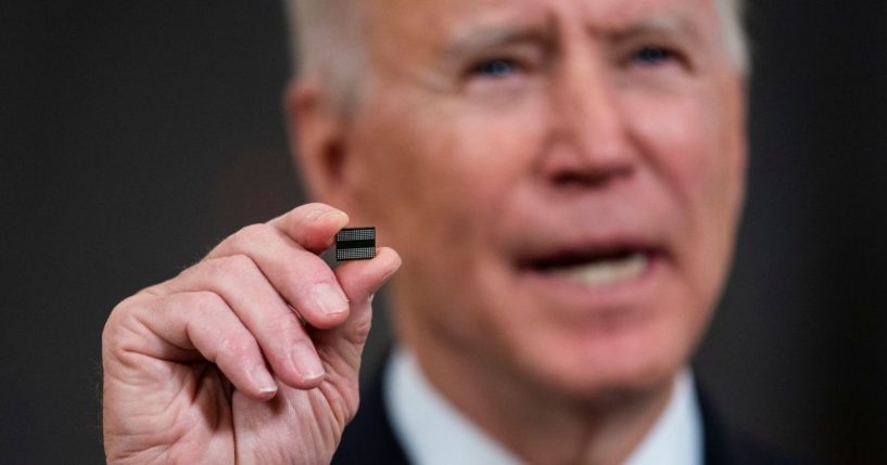 President Joe Biden holds a semiconductor during remarks in the State Dining Room of the White House on Feb. 24, 2021, in Washington, D.C.