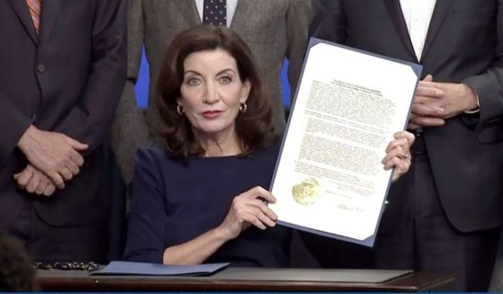 In an image taken from video, Democratic Gov. Kathy Hochul of New York shows an executive order she signed during a news conference in New York City on Wednesday.