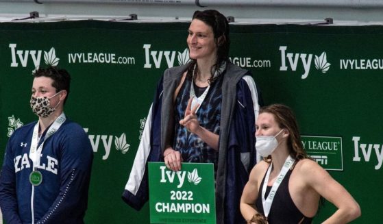 Trans athlete Lia Thomas, middle, stands on the podium after winning the first place medal in the 100-yard freestyle swimming race at the 2022 Ivy League Women's Swimming & Diving Championships at Harvard University on Feb. 19.