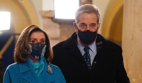 Speaker of the House Nancy Pelosi, left, and her husband Paul Pelosi, right, enter the Crypt of the U.S. Capitol prior to the inauguration of President-elect Joe Biden on Jan. 20, 2021.