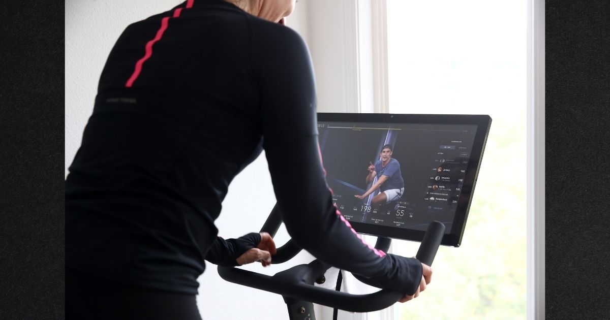 A customer uses a Peloton fitness program on a home exercise bike. The House of Representatives has drawn criticism for offering taxpayer-funded Peloton memberships at no charge to thousands of House staff and Capitol Police officers.