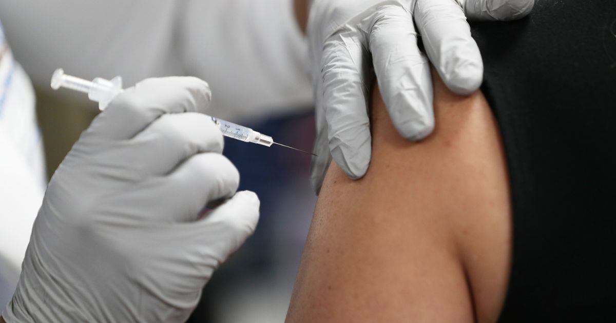 A patient is getting ready to receive a Pfizer-BioNtech COVID-19 vaccine at the Jackson Memorial Hospital in Miami, Florida, on Dec. 15, 2020.
