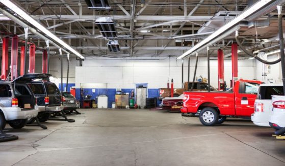 Trucks and cars are seen in this auto shop photo.