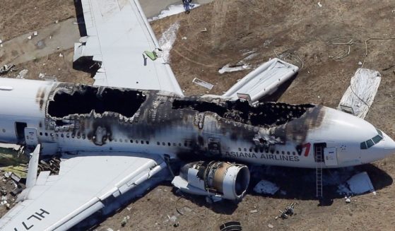 Nine suspects were detained Tuesday after multiple passengers received disturbing photos on their cell phones of plane crashes, including shots of this Asiana Airlines jet, which crashed in 2013 in San Francisco. The Istanbul-bound flight, which had been preparing for takeoff, returned to the terminal, where baggage was searched and passengers questioned. The flight safely resumed five hours later.