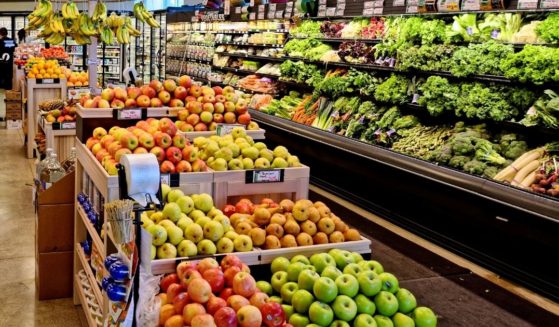 Fruits and vegetables are displayed in a grocery store produce section.