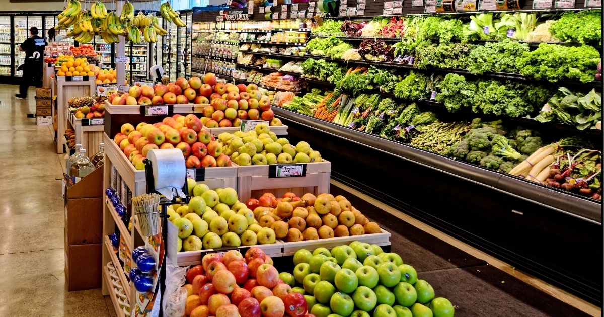 Fruits and vegetables are displayed in a grocery store produce section.