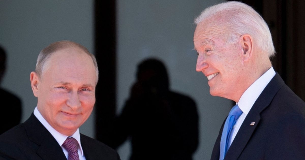 Russian President Vladimir Putin, left, and President Joe Biden shake hands and smile before their summit at the Villa La Grange in Geneva on June 16, 2021.