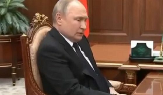 Russian President Vladimir Putin appears less than healthy in a video that shows him holding tightly to a table, apparently to prevent his hand from shaking.