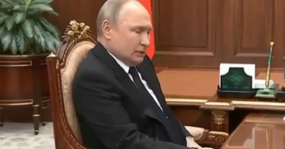 Russian President Vladimir Putin appears less than healthy in a video that shows him holding tightly to a table, apparently to prevent his hand from shaking.