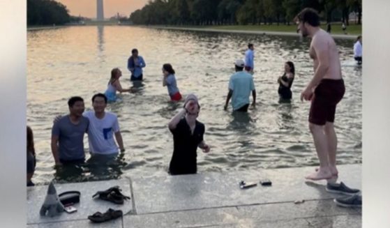 Students from Georgetown University were seen in the Reflecting Pool outside the Lincoln Memorial on Saturday morning.