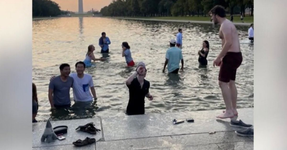 Students from Georgetown University were seen in the Reflecting Pool outside the Lincoln Memorial on Saturday morning.