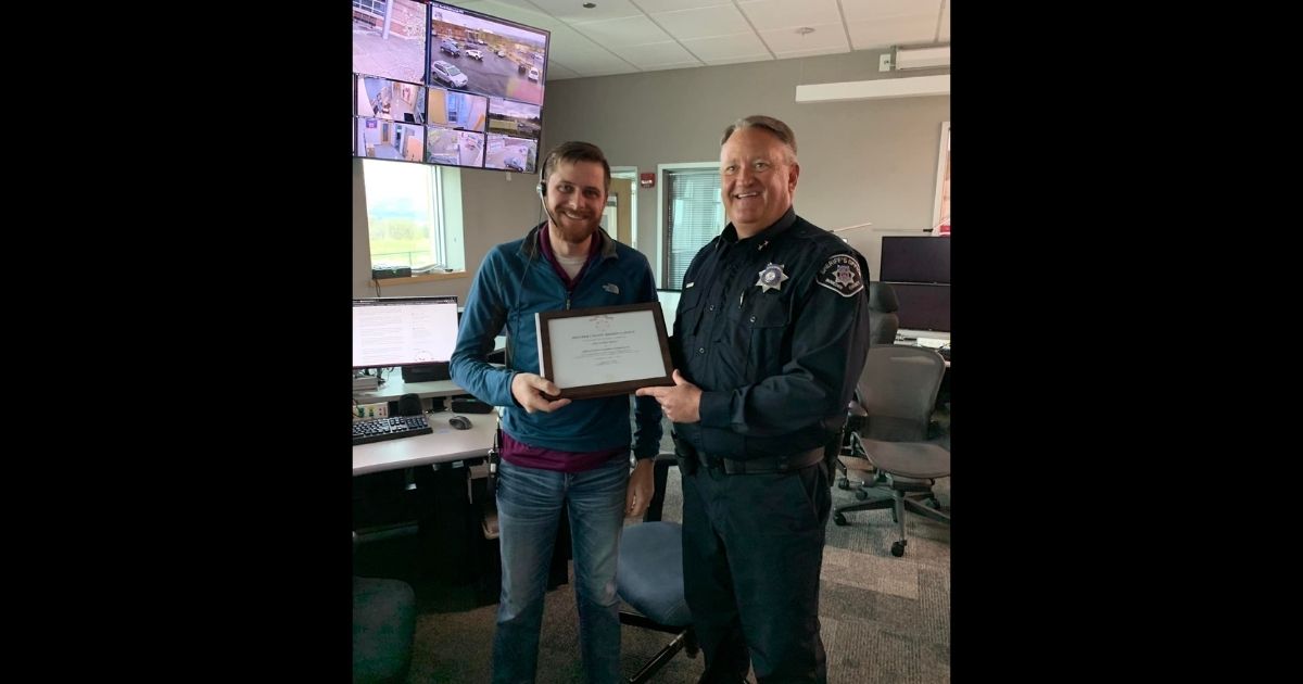 Dispatcher Rob Schimoler, left, receives an award in recognition of his actions.