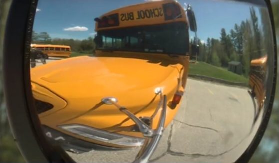 The boy's backpack was caught in the school bus doors as they shut. The driver accelerated, dragging the child alongside the bus.