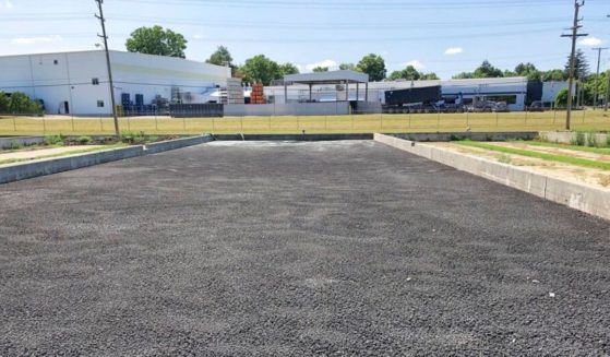 Sewage sludge from Michigan's Lapeer Wastewater Treatment Plant is held in drying beds in this file photo from July 2019. Around 20 million acres of U.S. farmland may have been contaminated after the biosludge was used as farm fertilizer. Later, such sludge was found to contain toxic PFAS chemicals, potentially contaminating crops.