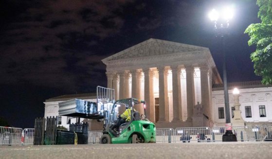 On Wednesday night, workers set up un-scable fencing around the U.S. Supreme Court in Washington, D.C., in preparation for protests sparked by a leaked draft of a majority opinion from the justices that would overturn the 1973 Roe v. Wade decision.