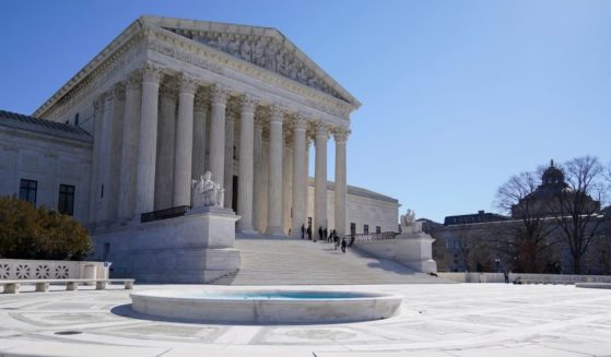 People standing on the steps of the U.S. Supreme Court building