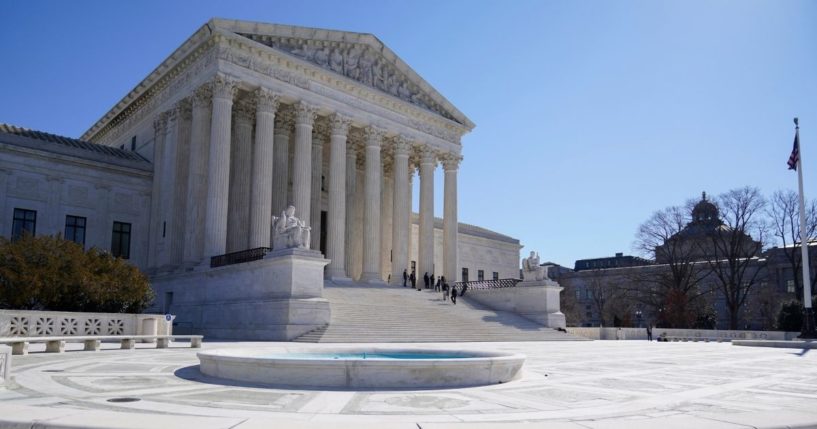 People standing on the steps of the U.S. Supreme Court building
