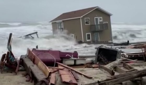 A home in Rodanthe, North Carolina, is swallowed up by the sea as storm surges lifted the unoccupied house off its foundation.